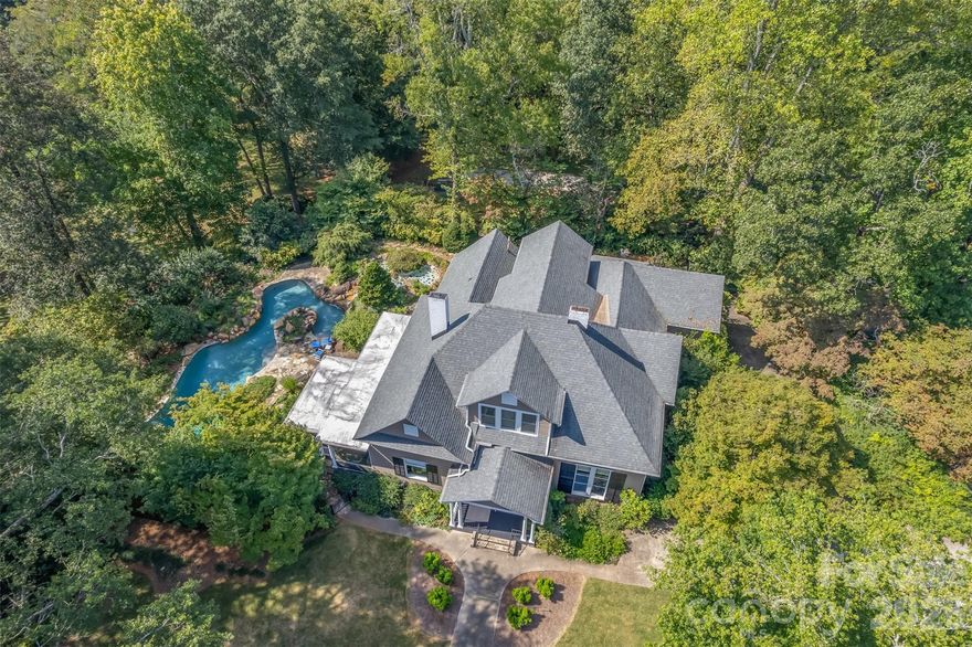 Are you searching for a home that blends timeless character with luxurious outdoor living—all on a spacious piece of land in the heart of downtown? From the moment you step onto the grounds, you're greeted with wow factors at every turn. The showstopping saltwater pool features waterfall elements, creating a resort-like feel. Whether you're entertaining, birdwatching, gardening, or sipping sweet tea, the outdoor space is a dream. The property includes a full bocce court and an additional parcel offering over 2.5 acres of recreational space—an incredible find in downtown. Inside, the 4,000+ square foot home features 5 bedrooms, 3.5 bathrooms, multiple fireplaces, oversized closets, an office, a billiards room, a wine cellar, and a grand foyer with stained glass. With so many charming features, this is a must-see property! Schedule your private tour today!