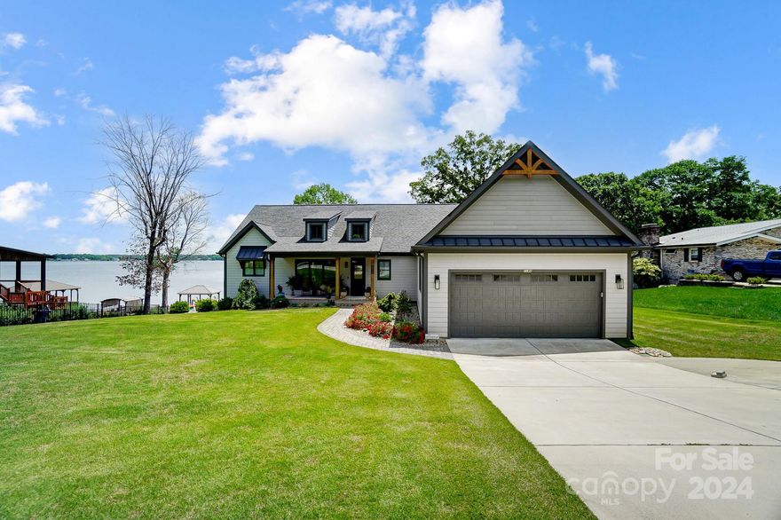 Wake up to spectacular main channel sunrises every day.  This home offers lake living at its finest.  The living and dining room sports 18 foot ceilings with a open concept living.  The kitchen offers lots of counter space and a large island with beautiful leathered granite, perfect for entertaining.  The large butler's pantry offers lots of storage for small appliances, and a cabinet with wine and bar storage.  The Primary bedroom has main channel views through French doors.  The En-suite has a large shower with two shower heads, and quartz countertops. The split floor plan offers two additional bedrooms with a jack-n-jill bath.  The walk-out basement has a kitchenette, living room, the 4th bedroom, and a bathroom. The large main-level garage offers over 801 sq feet, while the basement level garage gives 485 sq. ft for lake storage.  With over 1700 sq. ft of outdoor living, enjoy the lake views on the porch, in front of a roaring fireplace.  Owner is a licensed Realtor/Broker.