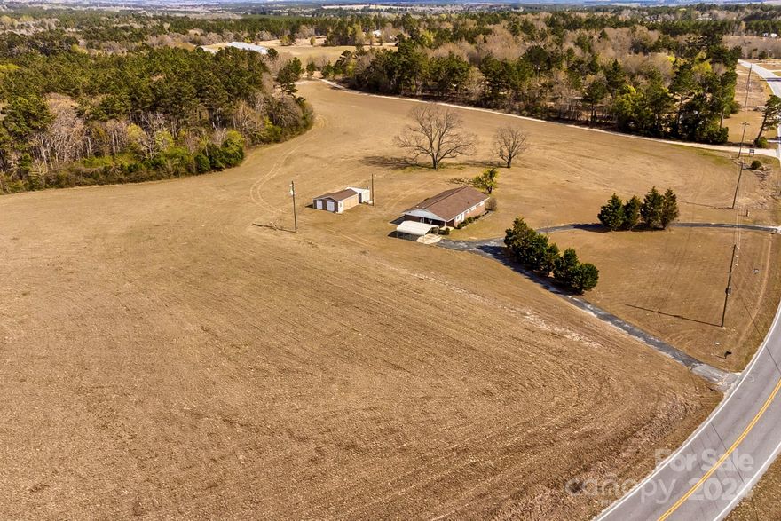 4 BEDROOM... 2 FULL bath home situated on 25.62 ACRES in a nice quiet country setting. Home offers fireplace with built-ins and gas logs...formal dining...open floor plan...Workshop and storage building. Half of the acreage is planted in coastal bermuda.