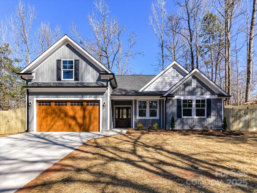 Welcome to this stunning new construction ranch home! Featuring a versatile bonus upstairs with a half bath, this property offers both comfort and style. The main level boasts a gorgeous kitchen with white cabinets, quarts countertops and a large blue island with designer lighting, perfect for gatherings. The master bath is a retreat with a huge custom walk-in tiled shower. Enjoy the vaulted two-story living room, a covered back porch, and a privacy fence in the backyard. Additional highlights include a two-car garage, a beautiful wooden front door, and a charming barn door in the primary bedroom. York location but Clover school district. Don't miss out on this exceptional home!