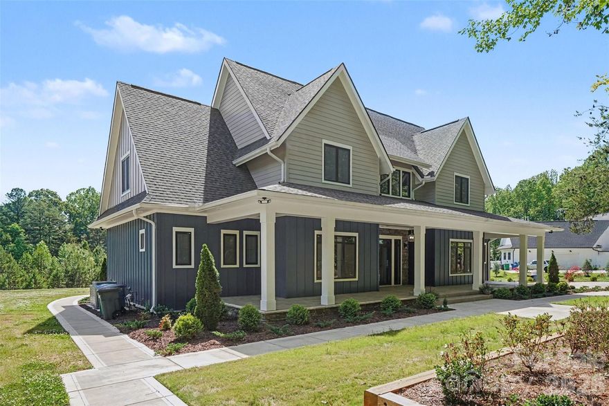 Set behind gated entry on a private two-acre parcel inside the I-485 loop, this custom farmhouse delivers rare privacy without sacrificing proximity. The setting is framed by mature trees and tranquil pond views, creating a peaceful backdrop for everyday living and entertaining. A striking modern exterior is accented by imported European windows and doors, showcasing refined architectural craftsmanship throughout.

Inside, wide-plank white oak floors and designer-selected lighting establish a clean, elevated aesthetic. The main level is anchored by a spacious primary retreat with direct patio access, a customizable walk-in closet, and a spa-inspired bath featuring a seamless zero-entry shower and deep soaking tub. The kitchen commands attention with quartz surfaces, Z-Line appliances, an expansive pantry, and a walk-through scullery equipped for serious hosting, including an additional oven, dishwasher, and prep sink.

Purpose-built spaces enhance daily function, including a dedicated workstation, an oversized laundry and drop zone with convenient driveway access, and a secondary full bath on the main floor. The three-car garage includes a drive-through third bay and is complemented by an additional drop zone off the interior entry. Outdoor living continues on the covered rear patio with fireplace, overlooking a level backyard ideal for gatherings or future enhancements.

The upper level offers three generously sized bedrooms—one with a private bath—along with multiple flex and entertainment areas complete with a kitchenette, providing space to unwind, host, or adapt to changing needs with ease.

Photos virtually staged.