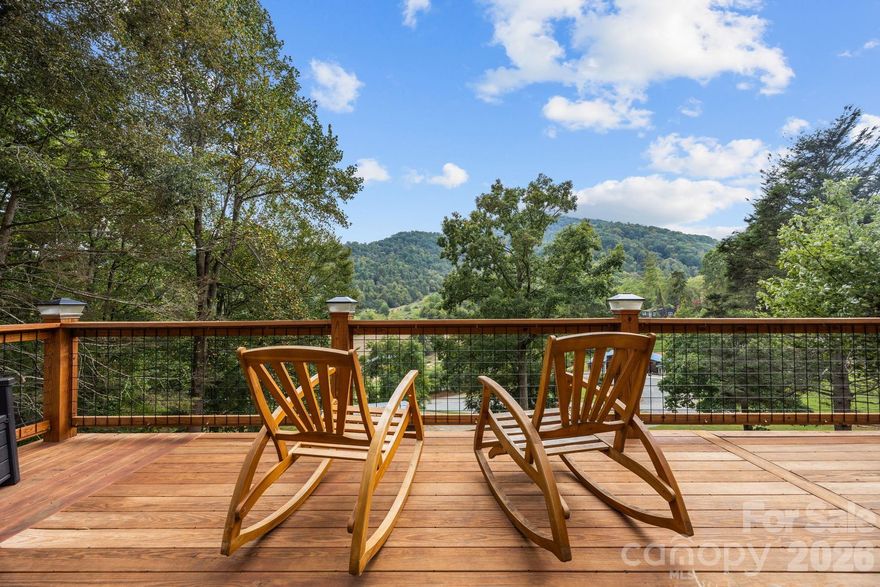 Mountain Retreat with Incredible Views! Enjoy modern comfort, scenic beauty, and endless possibilities with this exceptional mountain property. Set on terraced land with sweeping Blue Ridge views year round it is a perfect private retreat.Updated 3BR/2.5BA contemporary ranch with 2 bonus rooms used as bedrooms, stylishly remodeled tile baths, and a luxurious primary suite with soaking tub & walk-in shower.  Spacious kitchen eat-in kitchen with large island and tons of storage!   Full basement with 2-car garage, mudroom , expansive decks with large covered area , stamped concrete patio, and fire pit for enjoying cool, crisp mountain nights!