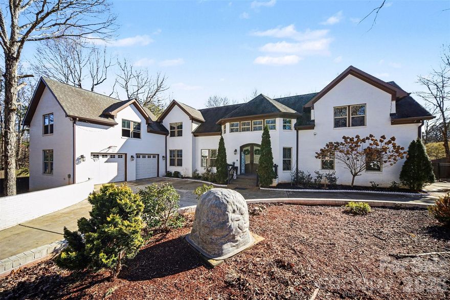 This exceptional custom home in Arlington Forest blends timeless architecture with modern luxury across more than 4,300 square feet of beautifully finished living space. Privately set on nearly half an acre, the property is surrounded by mature trees and wooded views, creating a serene retreat just minutes from the conveniences of Charlotte.

From the moment you arrive, the stately exterior, circular driveway, and attached two-car garage set the tone for the elegance found inside. A grand foyer welcomes you with sweeping architectural details, extensive millwork, tray ceilings, and gleaming wood floors that flow throughout the main living areas. The two-story layout offers five spacious bedrooms and four full baths, including a luxurious primary suite designed for comfort and indulgence.

The chef’s kitchen is both stunning and functional, featuring a large center island, custom built-in cabinetry and walk-in pantry. Designer lighting and premium finishes elevate the space, while seamless flow into the dining and living areas makes it ideal for both intimate gatherings and large-scale entertaining.This home also offers a private bedroom and full bath on the main level—perfect for guests, multigenerational living, or a dedicated secondary suite

The primary suite is a true sanctuary, highlighted by an expansive walk-in closet and spa-inspired bath complete with a garden tub, dual vanities, and a beautifully tiled walk-in shower. Secondary bedrooms are generously sized, and additional flexible spaces—including an office and bonus areas—provide versatility for work, fitness, or recreation. Storage is abundant throughout the home with extensive closet space, and a crawl space foundation offering additional utility. The upper-level laundry room adds convenience, while thoughtful built-in features enhance organization and everyday living. There is an large unfinished space above the garage perfect for  additional storage or adding additional square footage to the home. 

Outdoor living is equally impressive. A covered deck overlooks the private, fenced backyard, offering a peaceful setting for relaxing or entertaining amid mature landscaping and wooded surroundings. With a paved, publicly maintained road and no HOA, the property offers both privacy and freedom.

This is a rare opportunity to own a refined, move-in-ready luxury residence that combines elegant design, extensive upgrades, exceptional storage, and a tranquil setting—while remaining close to shopping, dining, and major thoroughfares.