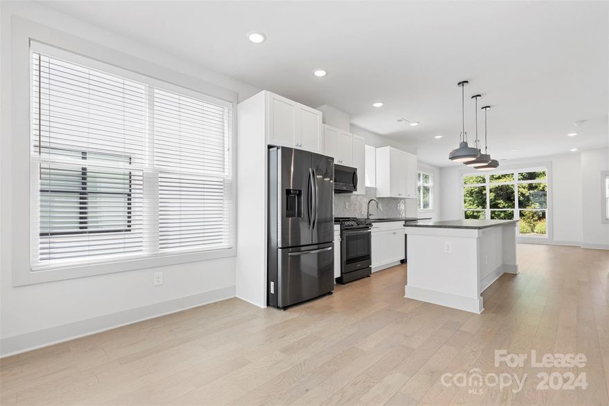 Discover the epitome of modern urban living at this 2 beds, 2.5 baths townhome in Charlotte, NC. This stunning residence boasts luxurious LVP flooring throughout. Stay comfortable year-round with the convenience of two nest thermostats, providing efficient and customizable climate control. Large windows invite abundant natural light, creating a bright and inviting atmosphere throughout. Featuring a beautifully designed kitchen, with a sleek tile backsplash and a spacious kitchen island, perfect for culinary adventures. The hands-free kitchen faucet, powered by battery operation, adds a touch of innovation and ease to your daily routine. Indulge in the spa-like experience of the primary bath, complete with a walk-in shower adorned with tile surround and a dual vanity that offers ample space for personal care. EV outlet. One of the standout features  is the expansive rooftop terrace, offering breathtaking views and an ideal space for relaxation or gatherings. Schedule a tour today!