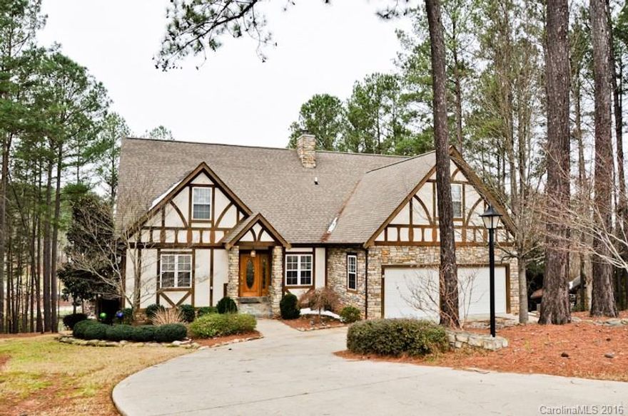 Lake Front Living at it's finest! This 3 BR, 4 BA home has over 4500 heated sq ft. The rear has a covered porch that runs the full length of the house for wonderful outdoor entertaining. Walk to the covered boat dock or the patio area that has a waterfall for even more outdoor fun. The interior has vaulted ceilings & open floor plan. Lots of water views. Everything you would expect including, wood flooring, moldings, security system, granite counters, SS appliances & a sub-zero refrigerator.