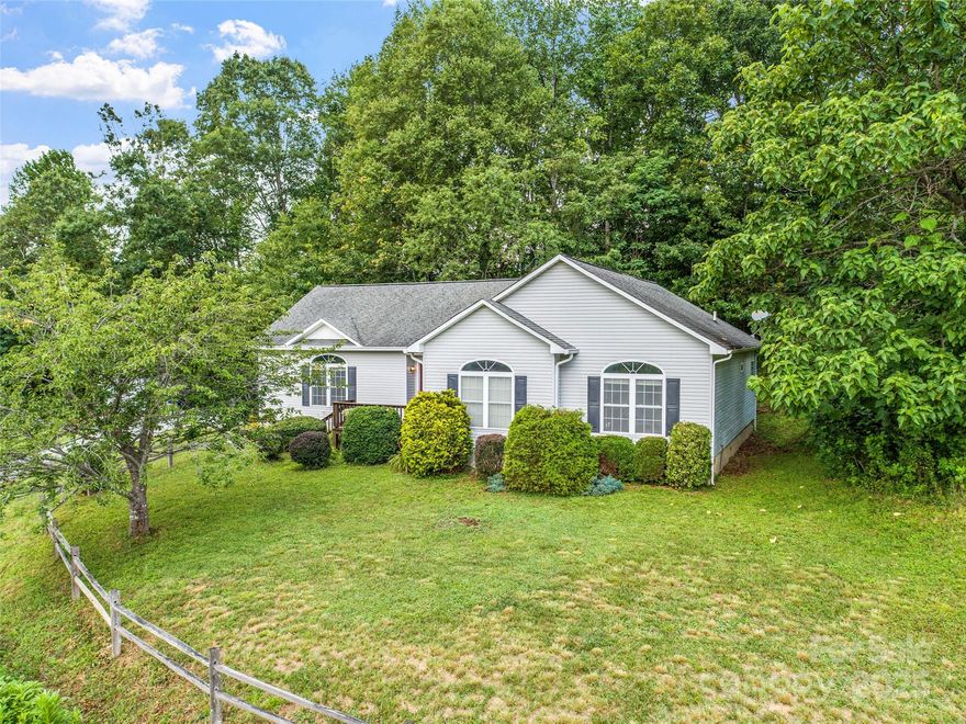 Experience the best of WNC living in this well-appointed, private setting, 1976 sq. ft home. Built in 2004 w/recent hickory hardwood flooring, HVAC, water heater, appliances & premium paint, home is turnkey ready for immediate stress free living. Just 10 minutes from downtown Burnsville. Home features an open floor plan with 9’ ceilings. Natural light streams into oversized windows, framing spectacular long-range mountain views. The spacious kitchen flows seamlessly into the dining area, creating an ideal setting for entertaining family & friends or just enjoying everyday meals. Retreat to the large primary ensuite, a private sanctuary w/tray ceiling featuring a whirlpool tub & shower, a double vanity, and a generous walk-in closet. 10x12 outbuilding for add'l storage. With its thoughtful layout & stunning mountain views this home provides a serene escape w/o sacrificing accessibility to the best of WNC making it an excellent choice for a year-round residence. 50 mins to Asheville-