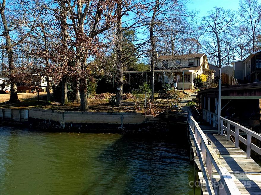 Welcome to this 3-bedroom lakehouse located on High Rock Lake in Rowan County, offering the perfect setting for comfortable lakefront living. This home is designed to take full advantage of its location, with expansive lake views that can be enjoyed from both inside and out. A large covered deck provides an ideal space for entertaining, relaxing with family and friends, or simply taking in the peaceful surroundings and beautiful sunsets over the water. The waterfront features a large pier with a covered stationary section, perfect for lounging in the shade, as well as a Trek-board floating dock that makes enjoying boating, swimming, and fishing easy and convenient. Also offers railing and covered boat storage for protecting your watercraft when not in use. Whether you’re looking for a full-time residence, a vacation home, or a weekend getaway, this lakehouse offers a wonderful opportunity to enjoy everything High Rock Lake has to offer in a quiet and scenic setting.