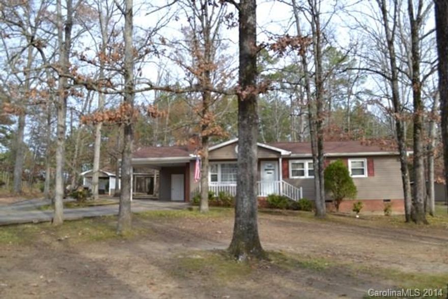 Cute as can be!  This ranch home offers a large open great room, dining area and kitchen!  Home was vinyl wrapped approximately 6 years ago, replacement windows throughout, roof only 3 years old.  Single attached carport.  Lots of additional vehicle coverage as well.  A must see home!  HVAC will need to be replaced.