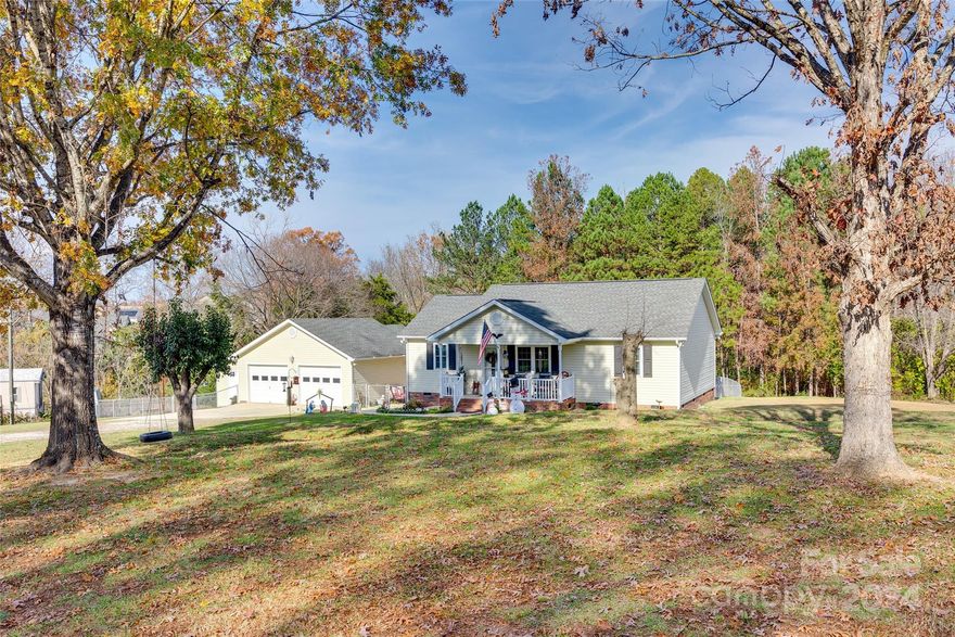 Beautiful 3-bedroom, 2-bath home on large 2.37 acre lot, perfectly located off Fort Mill Hwy. This home features hardwood, LVT flooring, and new paint throughout. Elegant chair molding accents the living and bedroom spaces, with stylish wainscoting in the bathrooms. Enjoy all the space outdoors on the welcoming front porch or spacious back deck. The property includes a detached 864 sq. ft. garage with a versatile space for a workshop or game room. Conveniently located near shopping, grocery stores, and restaurants, and zoned for top-rated Indian Land Schools. A must-see!