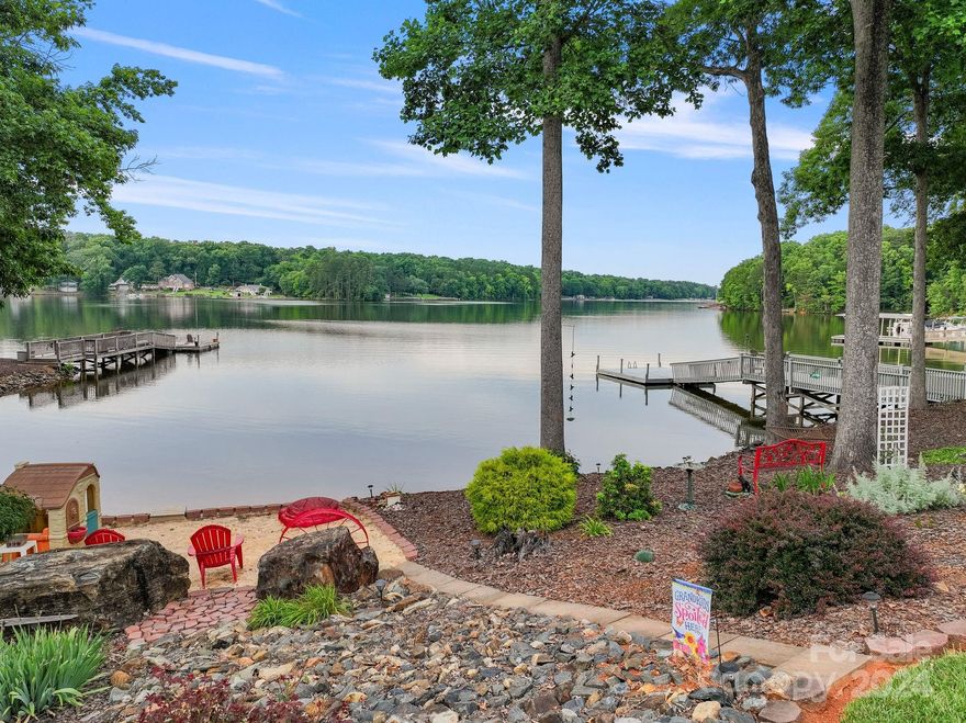 Lake life at its best! This beautiful lake house home has been meticulously maintained inside & out AND landscaped to perfection!  Located just 9 minutes from Denton/25 minutes to Lexington & 30 minutes to Salisbury, in a gated community. You have an easy gently sloping walk to the lake and your shared pier. Enjoy the most amazing sunrises & sunsets from the comfort of the main level primary bedroom, living room, porches, or backyard. You can enjoy the view of High Rock Mountain from the covered front porch. Great amenities in neighborhood: clubhouse, exercise room, book exchange library, boat storage, playground, tennis & pickleball court & community boat launch ramp. New roof installed in 2024, 2 new HVAC units 2021!