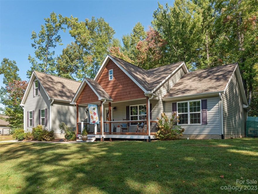 Lovely single level bungalow w/F.R.O.G. on an immaculately maintained 1.2 acres of land in a tucked away neighborhood. Enjoy the abundant natural light in the spacious living room area w/vaulted ceilings & rich wood floors. Open floor plan design for easy living w/ living & dining areas flowing right into the beautiful kitchen equipped w/stainless steel appliances, granite counters & ample cabinetry. Split floor plan w/spacious primary bedroom suite having its own private bathroom an gorgeous tiled shower and walk-in closet. There are 2 spacious bedrooms & guest bathroom plus double garage. There is a bonus room above the garage great for game room, office. Covered back deck makes the perfect spot to enjoy the outdoors along with a sunset mtn. view from your covered front dreck. All just a short drive to West Asheville, downtown Asheville along with close by shopping & dining. Interstate travel is close by as is air travel. Come see why they call it Oasis Cove, it's a great location!