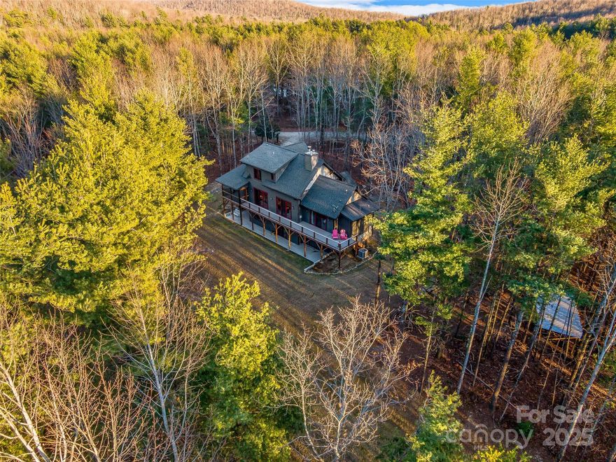 Located just 2.5 miles from the gates of DuPont State Recreational Forest, this 2019 Moss Creek custom design masterfully blends authentic timber-frame craftsmanship with modern luxury. Nestled on 6.27 private acres that directly border a massive 1,000-acre conservation tract, the property offers a permanent wilderness sanctuary and an unparalleled "infinite backyard" feel. The home's heart is a magnificent Great Room featuring wood-clad cathedral ceilings, rich hardwood floors, and a monumental floor-to-ceiling stacked stone fireplace. The thoughtfully designed layout includes 5 spacious bedrooms and 3.5 baths, featuring a terrace level complete with a secondary den and a high-performance hybrid gym and recreation room outfitted with a private sauna—the ultimate recovery space after a day of mountain adventures.

The exterior living spaces are equally impressive, with expansive decks and a serene screened porch that overlook a private mile of on-site trails. This offering includes deeded access to a pristine 28-acre private lake, reachable via a short, scenic stroll or a quick drive down a dedicated neighborhood access road. Engineered for total peace of mind, the home features dual Rinnai tankless water heaters, a 1,000-gallon propane tank, and a code-integrated dual-fuel generator. Residents also benefit from unique community conveniences, including a caretaker’s cabin that manages all package deliveries and centralized waste disposal. Whether you are seeking a quiet mountain escape or a sophisticated home base for world-class hiking, biking, and paddling, this Moss Creek estate represents a rare and irreplaceable opportunity in the heart of Western North Carolina.

Leave the driveway turn right and few hundred yards on your left is an gravel/dirt road bed that will take you right to the lake.