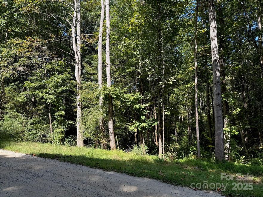 Espace to nature with this beautiful 1.8 acre wooded lot.  Nestled on a quiet gravel road this country property features a serene setting surrounded by mature trees and natural landscape.  A sloped terrain provides character and potential for unique building sites. Enjoy peaceful rural living while still being within reach of modern conveniences!  This lot comes with with a previous septic permit but has never been utilized.
