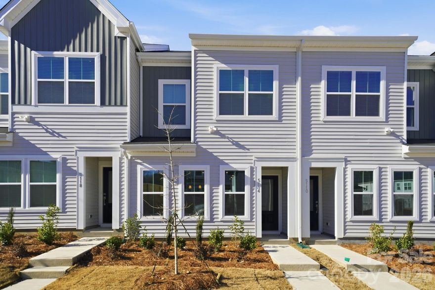 Discover the charm of this boutique townhome community built by Mungo Homes, a leader in quality craftsmanship & luxury design. This beautiful east-facing two-story townhome features 3 bedrooms, 2.5 baths, & a rear-entry one-car garage, offering an open-concept layout w/ stylish upgrades finishes throughout. The main floor boasts luxury vinyl plank flooring, creating a seamless flow through the bright & airy living spaces. The chef’s kitchen is a standout, featuring a large sitting island w/ granite countertop, stone gray cabinetry, tile backsplash, pendant lighting, & SS electric appliances! Upstairs, the spacious primary suite impresses w/ a boxed ceiling, generous walk-in closet, & a en suite bath w/ a quartz-topped dual vanity & a tiled walk-in shower. Two additional bedrooms, a full bath, & a convenient laundry closet complete the second level. Located 10 minutes from Uptown Charlotte, the airport, & side-walk acess to shopping at Target and Northlake Mall, Lakeview Village offers the perfect blend of style, comfort, & convenience. Ask about Move-in package and Financing Promotions! 2025 Parade of Homes GOLD Winner!