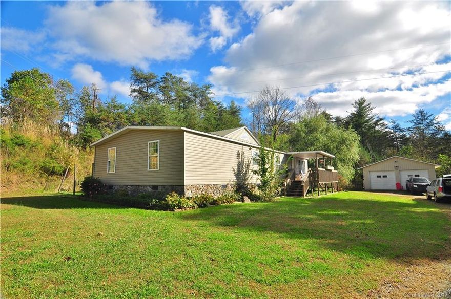 Great Open Floor plan house on a large lot that has plenty of level areas to enjoy and garden on with a detached 2 car garage.  Home has a large living room with fireplace, spacious kitchen and dining area and plenty of rooms.    Located minutes to Weaverville and Mars Hill.  Home has a 2 bedroom septic but plenty of extra rooms.