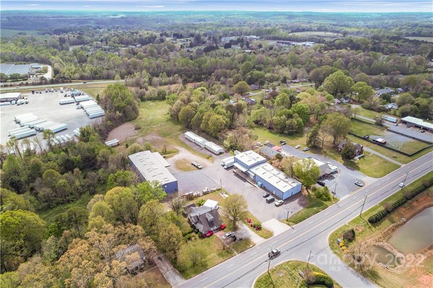 Great commercial property with potential to expand! Zoned B4 which covers many different types of businesses. Close proximity to I40 and I77. +/- 5 acres of land with 2 - 7,500 sq ft warehouses. Most of the land is behind the buildings. There is also 15 - 10x10 storage units and 30 - 5x10 storage units that creates a strong investment opportunity. Each warehouse has 1,000 sq ft of build out office space thats heated and cooled.  Both buildings have a men's and women's restroom and break room. Loading dock on each building with 2 roll up doors on each.  Approximately 25' ceilings in the warehouses. Ample opportunity here for a few different applications. Drone video attached.