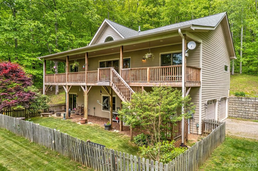 MOTIVATED SELLERS! Altitude affects attitude and this 3Br, 2.5 bth house is a rare find! 15 minutes to vibrant Asheville in the wooded oasis community of Fairview Forest, a 700-acre private planned community with private clubhouse, hiking trails, babbling brook & an incredible level of biodiversity. Built in 2006, this home sits on over 3 acres and has it ALL! Open concept with natural woodwork, soaring 17-ft tongue and groove ceiling, custom cabinets, kitchen island, wood burning stove, new well pump, newer heat and air with heat pump, abundant closets and a huge walk-in pantry. Primary bath boasts  spa tub, walk-in shower and huge walk-in closet. The downstairs has a huge walk-out basement with a laundry, mud room & an enormous 1200 sq ft. tandem 4 car garage w/ enough room for a workshop. Come sit on the  54-ft front porch to take in the  views and abundant sounds of nature!