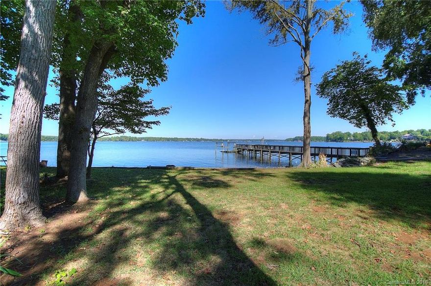 MAIN CHANNEL! Three bedroom home on an exceptional waterfront lot with a panoramic view of Lake Wylie! Sandy beach for sunning and relaxing by the lake, flat lot for easy access. Designed to enjoy the lake lifestyle: wrap around deck, rec room, covered patio, +/-160' shoreline with dock in place. Kitchen opens to great room with dining & living, large stone fireplace. Enjoy "as is" as a vacation home, or update a bit for full time living. Excellent Clover school district, low county taxes.