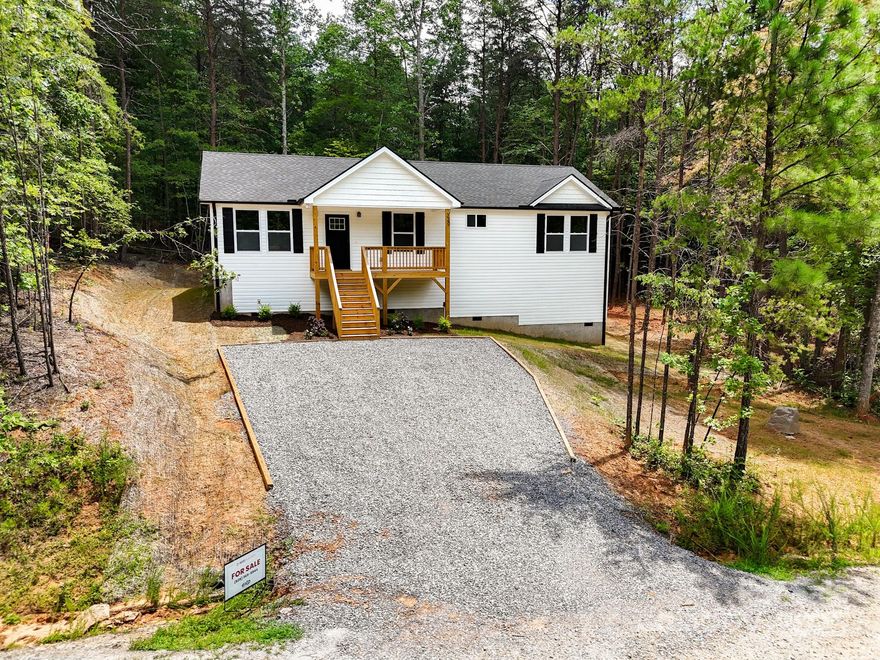 Discover modern mountain living in this brand-new home in Marion! Just minutes from downtown, enjoy local favorites like Ingenious Coffee Roasters, Mica Town Brewing, and Main Street’s dining scene. Outdoor lovers will appreciate nearby Tom’s Creek Falls, the Catawba Greenway and the Blue Ridge Parkway. Inside, an open floor plan bathed in warm natural light is perfect for entertaining. The spacious primary suite features a walk-in closet and a luxurious bath with dual vanity and custom tile shower. Luxury vinyl plank flooring flows throughout, complementing a chef’s kitchen with stainless steel appliances, granite counters, soft-close cabinets, under-cabinet lighting, and an island ideal for casual dining. Step onto the spacious deck and savor the mountain air. This home is ideal as a full-time residence, relaxing retreat, or investment opportunity. Experience new construction comfort surrounded by small-town charm and outdoor adventure. Potentially up to $2,500 in closing credit.*