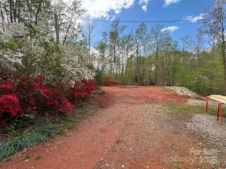 3.96 acre lot is prepped and ready for your new build, mobile home, workshop or maybe even a tiny house! No deeded restrictions! Existing 3 bedroom septic has been verified and inspected, well and water lines to site are in place. Two industrial steel container storage units sit on piers, power is connected. Large cleared and graded building site in place for your new project.  There is a camper on the site that is currently hooked up to power, water and septic. Camper can convey with property or be removed at closing.
