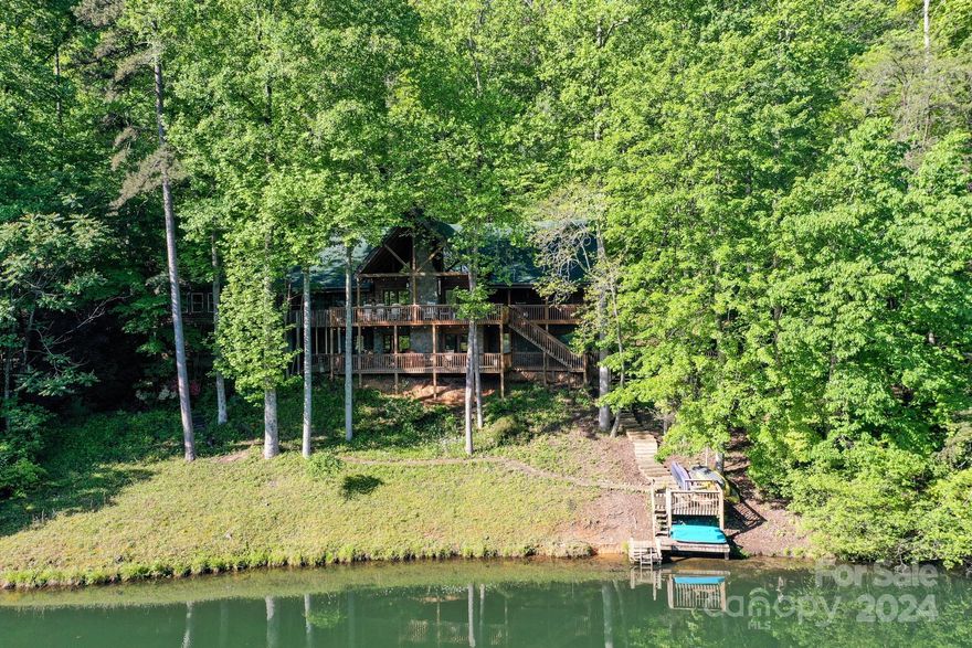 Lake Lure NC-----4800 sq ft lakefront home on Mirror Lake in Riverbend at Lake Lure. A real money maker for short term vacation rentals, grossing $171,000 in 2023.This large log cabin with its indoor pool is very popular with renters as it affords lakefront amenities and indoor amenities with plenty of activities to keep everyone happy, including; fishing, swimming, boating, hiking and so much more. Current sleeping arrangement is 5 bedrooms with lots of overflow space. Offered at $1,300,000. OBO
