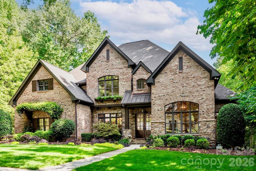 This prestigious custom home w/unparalleled luxury and comfort has an open main level floor plan, custom millwork, hardwood flooring, soaring ceilings. GR is complete w/stone fireplace flanked by built-ins, coffered ceiling. The gourmet kitchen is equipped w/an oversized island, custom cabinetry, 2023 Thermador ss appls, granite counters. The kitchen flows into a charming keeping rm, expansive screened porch. Primary suite has a resort-style bath, custom walk-in closet. Upstairs you'll find 3 large BR's, each w/ensuite bath, along with a flex rm that could be BR/bonus/office. Basement is an entertainer’s dream w/2nd kitchen, game rm, recreational space, exercise rm, guest suite w/full bath + laundry. The designated pool bath has direct access to the outdoor oasis including an in-ground saltwater pool, spa, fireplace, covered terrace, grilling area. Workshop, ample storage. Wired for Google Fiber, high-speed ethernet ports in 3 office areas and 3 BRs. GR TV is hardwired to the internet.