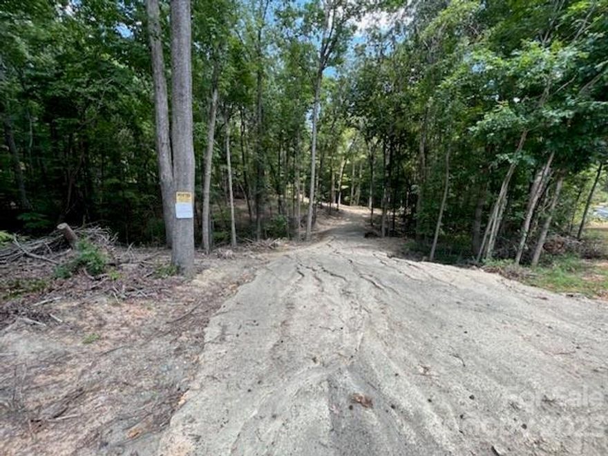 Serene 3-acre haven! Build your dream home amidst nature's beauty. This wooded retreat offers both privacy and convenience. Partially cleared for your home, a culvert is ready for your driveway. Surrounded by elegant homes, this location exudes tranquility. Enjoy wide road frontage and gentle slopes, perfect for your architectural vision. Embrace a lifestyle of harmony and luxury. Your oasis awaits!