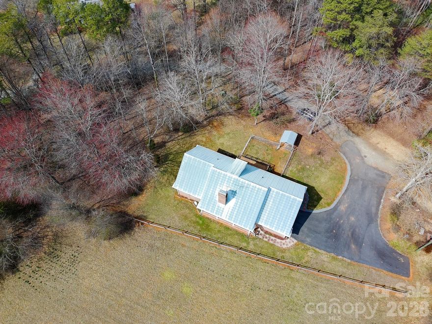 This 3-bedroom, 2-bath brick home offers comfortable living with beautiful views & a convenient location just minutes from downtown Elkin. The living room features a cozy gas log fireplace, creating a welcoming space to relax. In the kitchen, you’ll find granite countertops & stainless steel appliances, along with plenty of workspace for everyday cooking. Additional features include brand new HVAC, newer garage doors, an attached garage, & a paved driveway, dedicated laundry, and a security system that will convey. The home also includes propane as a backup heat source & a radon mitigation system already installed for added peace of mind. Upstairs, a large unfinished area provides great potential for future expansion. Outside, enjoy the fenced yard area & room to take in the surrounding views. With nearby access to local amenities, schools, wineries, and outdoor recreation, this home offers a great blend of comfort and location.