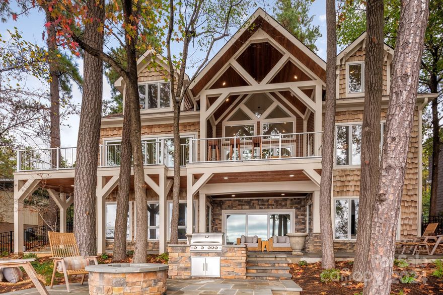 Stunning RENOVATED wf home w long range spectacular views of LKN! The perfect combination of luxury, convenience, & a relaxing lake lifestyle! Details such as the dramatic glass walls on the main floor that lead to a covered entertaining deck provide a stunning first impression, while the impressive stone fireplace greets guests w an extra touch of wow and charm. A large living room with high ceilings and gorgeous chef's kitchen and butler’s pantry offers ample space for entertaining. The flexible floor plan offers an exquisite primary suite with floor to ceiling windows and fireplace on the main level, 3 large bedrooms and sitting area upstairs, in-law suite w kitchen, great room, & large craft & laundry room on the lake level. Extra touches include primary bath with deep soaking tub and steam shower. Thoughtfully designed built in book cases, shelving and closets throughout, newly landscaped yard w extensive stone decks, built in fire pit & grill, new 10,000 lb lift & stone sea wall.