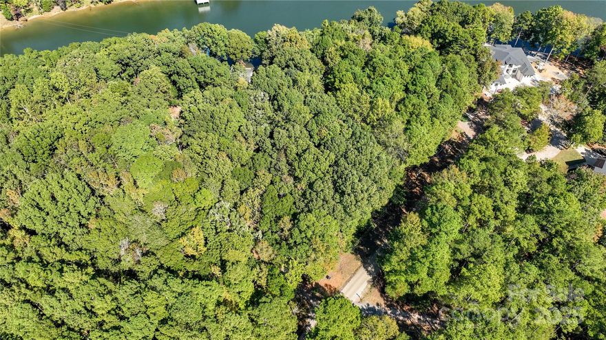 Discover the perfect blend of peace, privacy, and potential with this beautiful lakefront vacant lot. Nestled in a quiet and serene setting, this property offers tranquil water views and the soothing sounds of nature all around. Whether you’re dreaming of building a weekend getaway, a year-round home, or a retreat for relaxation, this location provides the ideal canvas. Enjoy the best of both worlds — peaceful lakeside living with convenient access to the city. The property is located approximately 25 miles from Uptown Charlotte and Charlotte Douglas International Airport, making it easy to stay connected while enjoying your own private escape. With its calm surroundings and endless possibilities, this is your chance to create your own slice of lakefront paradise.