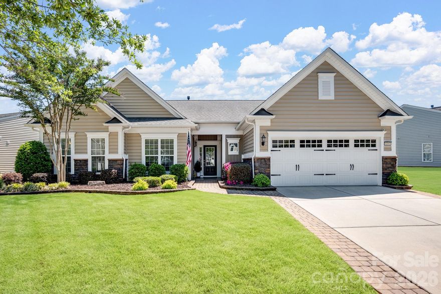 Tucked within the amenity-rich community of Sun City Carolina Lakes, this beautifully maintained Crestwood Meadow model blends comfort, style, and everyday functionality.

A charming paver walkway leads to a covered front entry, setting a welcoming tone. Inside, the foyer opens to a private home office framed by elegant double glass doors - an ideal space for remote work, creative pursuits, or quiet study. At the heart of the home, the open-concept great room invites gathering and relaxation, with a gas log fireplace and classic mantle.

Designed for both everyday living and entertaining, the formal dining room features detailed wainscoting accents. The kitchen is thoughtfully positioned at the rear of the home and impresses with a large island, granite countertops, tile backsplash, stainless steel appliances, and a gas range, along with a sunny breakfast nook for casual meals. Just beyond, a light-filled sunroom offers peaceful backyard views and an inviting place to unwind.

The primary suite, also located at the back of the home for added privacy, features a spacious ensuite bath with dual vanities, a glass-enclosed walk-in shower, dedicated vanity space, and a generous walk-in closet. Two well-sized guest bedrooms are situated at the front of the home with access to a full hall bath, providing flexibility for visitors or additional living space.

Practical touches include a laundry room with built-in storage and a utility sink, as well as attic space currently used for extra storage. Outdoor living shines with a screened patio complete with a ceiling fan - perfect for enjoying warm spring days - and a custom patio that overlooks the expansive backyard.

Residents enjoy access to an array of resort-style amenities, including golf, tennis, pickleball, scenic walking trails, water access, and a vibrant selection of social clubs, creating a lifestyle as exceptional as the home itself.