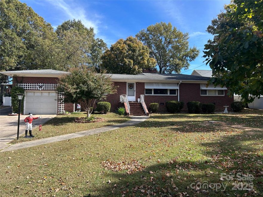 1950's charming ranch in Albemarle!  The home is brick and situated on just under an acre.  Huge, fenced in backyard with a storage building.  Also, a sunroom was added to the original structure.  There is a garage and a carport for your cars.  The home has many features including hardwood floors and a family room/den that is covered in wood on the walls and the ceiling. Three bedrooms, one bath and tons of space! Almost 1700 square feet excluding the 271 sq ft of sunroom that has been heated in the past.  This one will not last long!