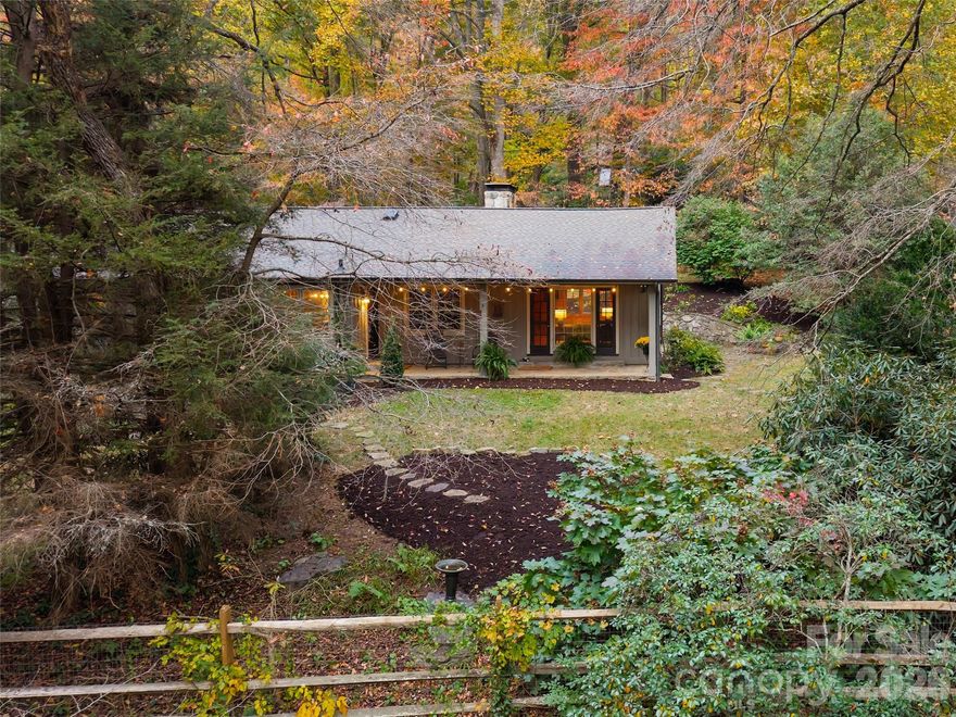 Rare. Your opportunity to cherish an original Sugar Hollow homeplace. Nestled in the historic and idyllic community where 'farm to table' is a reality, embrace living amidst conserved vistas and rural traditions of a life well-lived. This iconic mountain stone retreat is one of 11 cottages intentionally built in the 1950s by Chicagoans as a well-envisioned summer oasis. The 'Meadow' home boasts two granite fireplaces, one of which has an enameled Vermont stove. Original knotty pine walls and ceilings in the great room with an angled design and polished oak floor flow throughout. A restored galley kitchen with original cabinets has now been honored with Carrera marble countertops & modern improvements. Two bedrooms and two bathing rooms on the main level, and then down to a daylight family room, library, and bedroom/bath with an outside stone entrance. The native rhododendron forest has been embellished by a BBarnes perennial landscape, including hardscape paths leading to massive 100yr old boxwoods and azaleas. Dominant stone boulders and walkways showcase the patina of an alpine southern lifestyle. Custom gates by Simon Wilson. Custom wrought iron by Drew Shook. Sugar Hollow Road combines paved and gravel sections, slowing life down to allow for leisurely trail walking to the farm stores for your provisions. All at the base of Little Pisgah and the Eastern Continental Divide. Come live in the best-kept secret of the County. Come be one with Sugar Hollow.