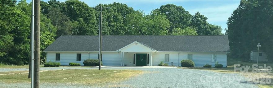 Many possibilities for this building. Has been used as a church and most recently an Academy. Lots of potential with over 3 acres. Being sold as-is.