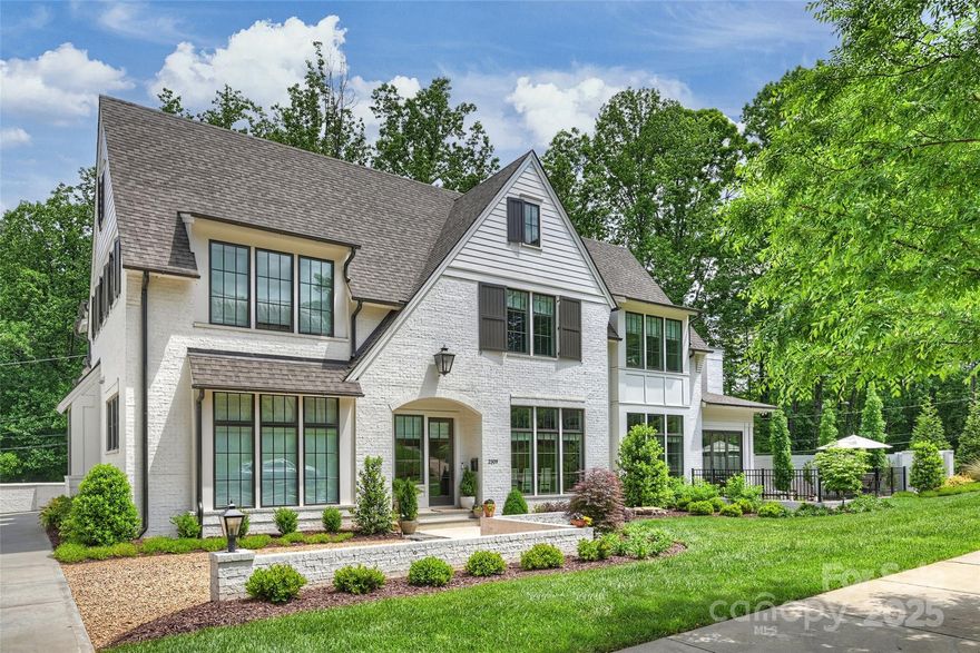 Prepare to fall in love with this Knight Residential Group gem in the distinguished Eastover neighborhood. This home is the epitome of luxury and convenience located just 2.5 miles from Uptown Charlotte's famed intersection at Trade and Tryon Streets. Step into the open floor plan with the chef's kitchen equipped with a Wolf range and paneled Sub-zero refrigerator and dishwasher. White oak hardwood floors and 10 foot ceilings throughout main level. Fully enclosed sun porch with gas fireplace and tri-fold glass wall invites you to the fenced terrace to enjoy indoor outdoor living. Large primary suite on main with remote-controlled blinds. New designer lighting and fabric blinds throughout the home. The second floor has 4 generous bedroom suites (each with private bath) as well as a media room. Laundry room accommodates 2 sets of machines. Yard fully landscaped with new brick privacy wall and irrigation system. 2-car attached garage used as a gym + 2-car pea gravel motor court in front.