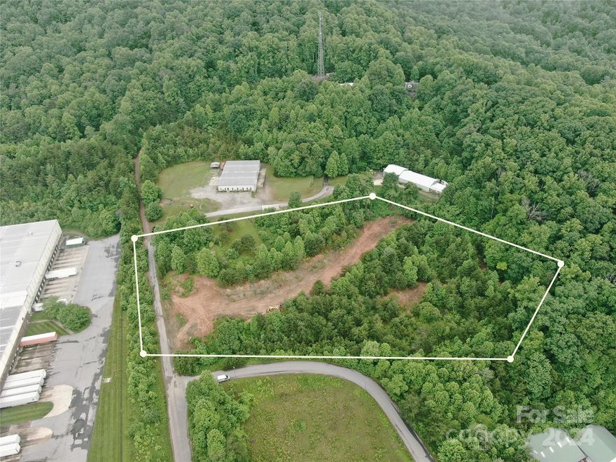 Now Available is this great commercial lot with a very convenient location right off Brevard Road. This lot has had some grading done to it with the middle area already being flat and cleared. The property is close to I-26 (within 5-10 minutes) and only about 5.4 miles from the Asheville Airport. Existing businesses are located around the property. Zoned EMP which provides potential for a large variety of business opportunities such as Retail trade, commercial services, Storage and warehousing, Manufacturing and processing operations, Motor vehicles maintenance and repair shops, etc. Boundary lines in photos are approximate and not exact.