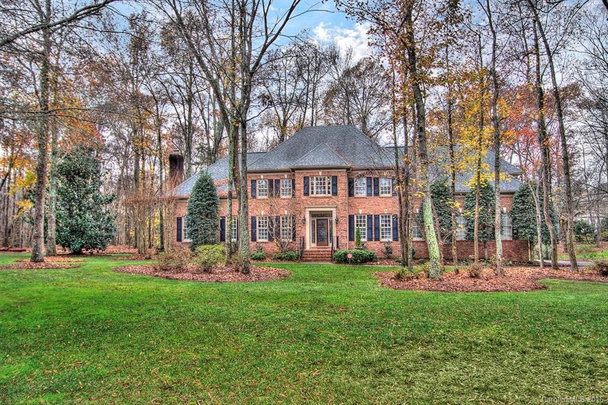 Elegant full brick trad home on almost full treed acre in Providence Country Club.  Gorgeous glass front door w/sidelights & transom welcomes you into soaring 2 story foyer leading into columned formal LR. Curved doorway into FR adjacent to gourmet kitchen w/granite, SS appls, tile backsplash & island w/gas cooktop plus butler's pantry w/wine fridge. Mstr features tray ceiling, FPL & chandelier & MBA has circular window & closet w/built-ins. Updated fixtures. Detailed molding, plant shutters.