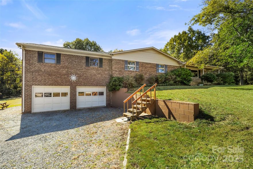 Are you long for a spacious brick ranch on acreage?  Do you hate the idea of an HOA telling you what you can and can't do?  Located in Indian Trail, with nearly 3000 HLA, a 3 car garage and 3.18 acres, this brick ranch is just what you're looking for! The main floor consists of an updated kitchen, 3 bedrooms, 2 full bathrooms and a bonus room. Open kitchen offers breakfast bar, SS, tons of lighting, abundant storage and work space. The finished basement includes full bathroom, rec room with wet bar plus a laundry room with utility sink. Covered back porch plus open deck perfect for entertaining, plus huge backyard. Rocking chair front porch. Hardwoods, ceiling fans. New roof 2025. Only a few minutes to the Sun Valley entertainment district, convenient to Hwy 74 and 485, this home is perfect for those looking for convenience and proximity paired with a pseudo country setting.  Indian Trail will allow an ADU up to 900 sq ft on the property. County sewer available on left and rear of the property for easy connection. Make an appointment to see 5303 Rogers Rd today. - Pre inspected with repairs completed