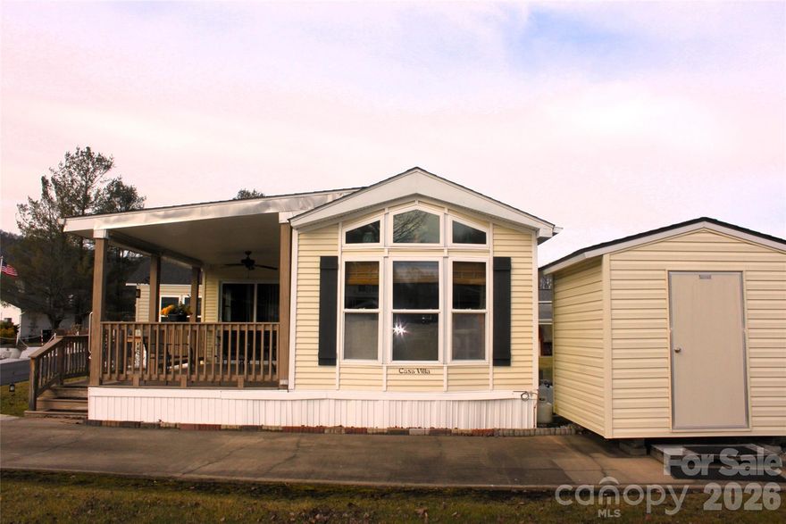 Welcome to easy mountain living at 29 Polka Lane, located in a well-maintained 55+ community just minutes from downtown Waynesville and Maggie Valley. This home offers 360-degree mountain views, enjoyed from a peaceful valley setting with level, paved roads that make everyday access simple and stress-free.

Inside, the home features three mini-split systems for efficient, customizable comfort year-round, along with a gas range that will appeal to anyone who enjoys cooking. The large, updated bathroom provides modern convenience and generous space, adding to the home’s comfortable and functional layout.

Outside, an additional storage shed/workshop offers plenty of room for hobbies, tools, or extra storage. And you will love relaxing on the spacious front porch, enjoying the scenery while entertaining with friends and family. 

This property is ideal for those seeking low-maintenance living, scenic beauty, and a welcoming community atmosphere, all while staying close to Maggie Valley and Waynesville’s shops, dining, and local amenities. This property is being offered fully furnished...the seller will be removing some small personal items. 29 Polka Lane delivers the combination of comfort, accessibility, and mountain charm that makes Western North Carolina so desirable.