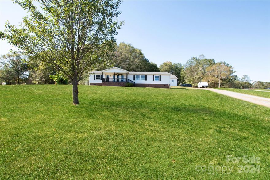 Welcome to this adorable 3 bedroom, 2 bath home, featuring a cozy covered front sitting porch that invites you to relax! Nestled on 1.64 acres, this property offers plenty of space for outdoor activities. As you step inside, you'll be greeted by a spacious open living room that transitions into a well-appointed kitchen. The kitchen is equipped with stainless steel appliances, an island/breakfast bar that opens up to the dining area—perfect for entertaining. The primary bedroom is a retreat, complete with an ensuite bathroom featuring a soaking tub and dual vanity. Additional highlights include a refrigerator that will convey with the sale, along with a garage wired for power, making it perfect for all your projects and new windows on the front of the home! Enjoy outdoor living in the large fenced backyard with deck. Don’t miss this fantastic opportunity to make this charming country home your own! Seller offering $5,000 in closing costs.