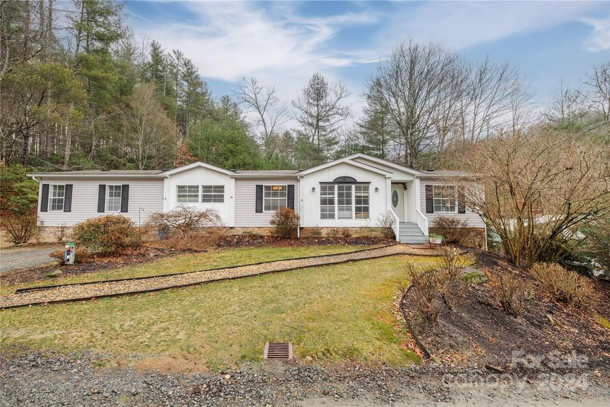 Welcome Home.  Upon entry you are greeted with a beautiful open floor plan with plenty of natural light and space to visit or entertain.  This extended living room is open to the dinning area and leads into the kitchen.  The kitchen has been beautifully remodeled and has a large island and breakfast bar which opens up to the family room.  Just off the family room is a spacious fully screened in back porch.  Grab your favorite book and soak up the privacy. Or it further expands the family room for even more entertaining purposes.  The large Primary bedroom offers a walk in closet with bonus room attached.  This bonus room has many options. Primary bath is spacious and is still plumbed for a tub if you wish.  The guest bedroom ensuite offers a separate sitting area from bedroom space. 
Detached garages (24x30 & 20x18) are have concrete flooring, insulated, air unit and propane heat along with air compressor.  Private setting but close to Dupont St Forest, Brevard and Hendersonville.