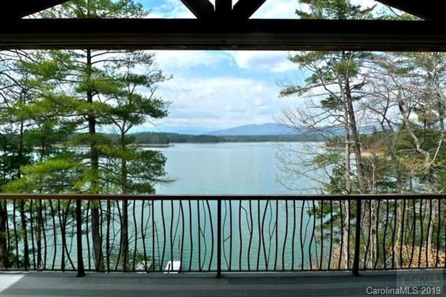 Amazing stone and timber cottage in private community on quiet, pristine lake surrounded by protected forests. Clear views across one mile of open water to Lake James State Park on the opposite shore.   French Gothic timber frame with custom lodge details, stone walls, faux slate roof, all copper roof metal and one-of-a-kind architectural sculptures and maple flooring throughout; all in the Adirondack tradition.  Large lakeside deck on ground and main floor, floating dock, gazebo on the water, cedar sauna for six, porte-cochere, roof top balcony, large lighted cupola, two story fireplace, kitchen garden, mature landscaping and plenty of parking. Spacious yet cozy with 7 BDRMs plus 7 Baths plus office,  family room,  full  basement and 2 car garage. The perfect home for watersports and entertaining with a big WOW factor. Visit www.mountainlakehouse.us for info and pics!