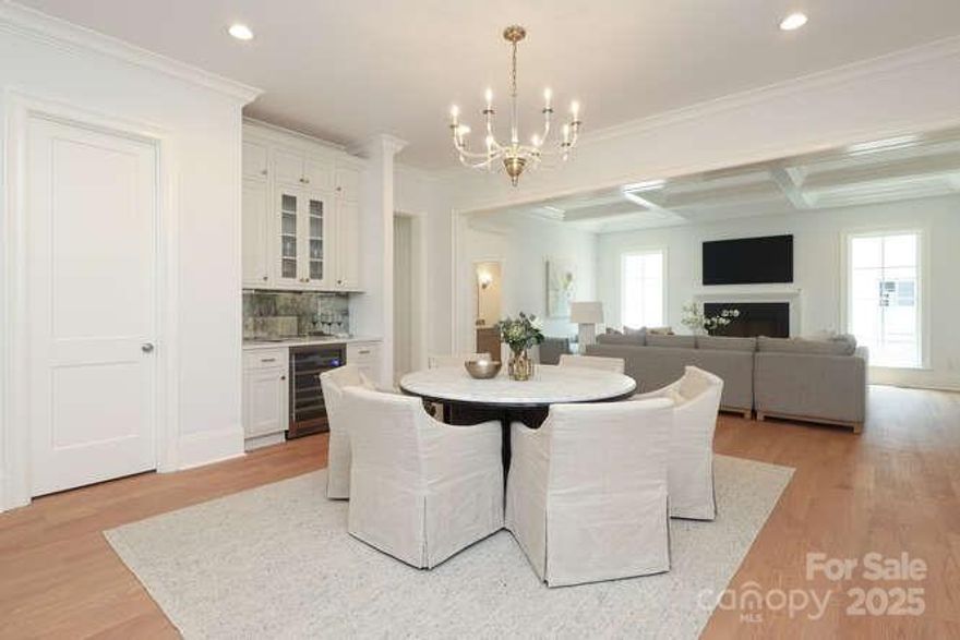 Modern interiors designed for everyday comfort and effortless entertaining. The expansive great room combines a chef’s kitchen equipped with top-of-the-line Thermador appliances, a walk-in pantry, and a beverage center, flowing into a spacious dining area and inviting great room.

The primary suite is conveniently located on the main level, while upstairs, you'll find a large media room, along with three generously sized bedrooms—each with its own full bath—and a huge finished walk-in seasonal closet. A screened porch with a fireplace complete the outdoor living.

Current owners invested an additional 100k in upgrades, including a full-house generator, whole-home water filtration system, upgraded designer lighting and tile, custom outdoor shutters and a fenced backyard. 

Just one block from Charlotte Country Club and a short stroll to Midwood Park, residents will enjoy beautifully landscaped grounds, connecting sidewalks, and ample guest parking.