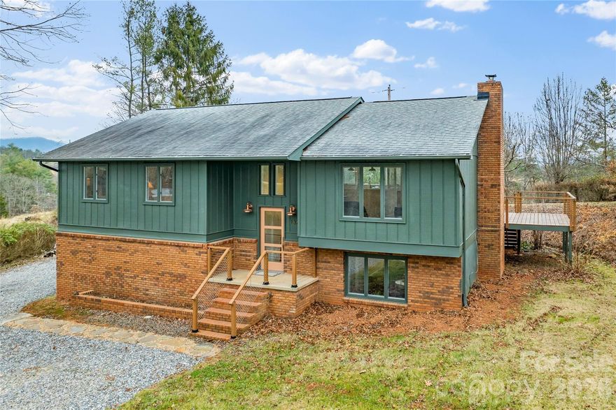 Perfect home and land retreat. Located exactly 22 minutes from River Arts District and 20 minutes, via beautiful country roads, to downtown Marshall. Rare combination of a beautiful "just right" house not overdone and certainly not underdone.  3 bedroom 2.5 bath completely renovated. Scandinavian inspired clean and bright with quality materials and finishes.  The interior environment was purposefully designed to draw your focus to the spectacular view.  Your plants will love the light. So many improvements this home is a pleasure to live in.  Hard wood floors throughout main floor, large windows and french doors added both in the living area and primary bedroom to capture amazing views and provide immediate access to newly installed deck that spans the whole length of the house.  All tile on lower level. Completely updated kitchen with custom cabinets, concrete counter tops. The view from the coffee bar looks out through the interior windows over the rest of the living area.  All new retro inspired "Big Chill" appliances are just so cool.  All new light fixtures and thoughtful accent lighting for art display throughout the spaces. All bathrooms redone with lovely tiles and stone and 1/2 bath added in laundry area on lower level.  New wood burning insert added and provides so much warmth and ambiance in the fabulous art studio/library/family room on lower level.  Whole house water filter provides clean delicious water right from the tap. Large utility room is so perfect for any projects or pets. One car garage is on lower level, and has interior access to utility room. The 17+ acres include woods, sunny pastures, creeks, and several natural springs.  Easy access via private road at the top of the property or off old Turkey Creek Road at the bottom of the property.  Great growing plateau just outside the back door. Stunning old growth trees anchor the view from the huge deck.  There is so much to see and appreciate with this property. We would love to tell you more.