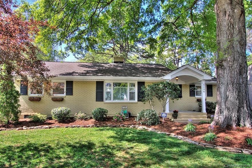 Immaculate full brick home in popular Sedgefield! Enjoy the scenic view of private backyard from the patio w/ pergola. Mature landscaped backyard is fenced w/ a finished, heated/cooled detached garage & workshop! Hardwoods thru-out & plantation blinds. Updated Kitchen & bath. Kitchen updates include new maple cabinets, granite, & black appliance package w/ refrigerator. Replacement windows.  Washer & dryer remain. Walking distance to lightrail, Freedom Park, & less than 5 min. commute to Uptown!