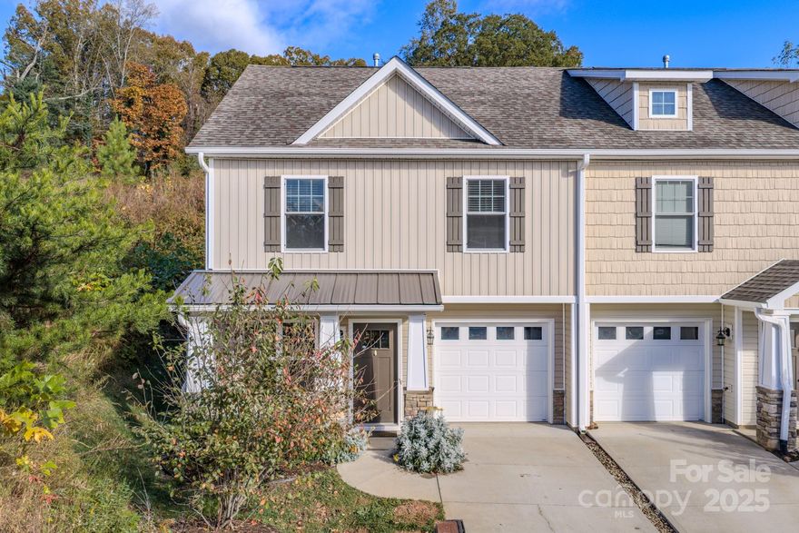 Discover effortless, low-maintenance living in this beautifully maintained end-unit townhome, ideally positioned just minutes from the shopping, dining, and entertainment of Asheville.

Fresh, modern updates set a warm and inviting tone throughout, including luxury vinyl plank flooring and soft, contemporary carpet selections. The main level offers an open, functional layout designed for everyday living and entertaining, featuring a stylish kitchen with stainless steel appliances, tile backsplash, and a dedicated dining area. The inviting living room is anchored by a cozy gas fireplace, while a convenient half bath and attached one-car garage add everyday practicality.

Upstairs, the spacious primary suite provides comfort and privacy with an en suite bath, along with two additional bedrooms that share a well-appointed full bath with a tub/shower combination. A laundry closet on the same level adds ease and efficiency to daily routines.

As an end unit, the home benefits from added natural light and a greater sense of separation than interior units. HOA-managed exterior maintenance, city water and sewer, and included services such as trash pickup offer predictable ownership costs and true lock-and-leave convenience.

Move-in ready and thoughtfully designed, this home is well suited for first-time buyers, downsizers, or investors seeking proximity to Asheville without the upkeep of a detached home. Bonus: Seller is including a transferable six-year home warranty for added peace of mind.