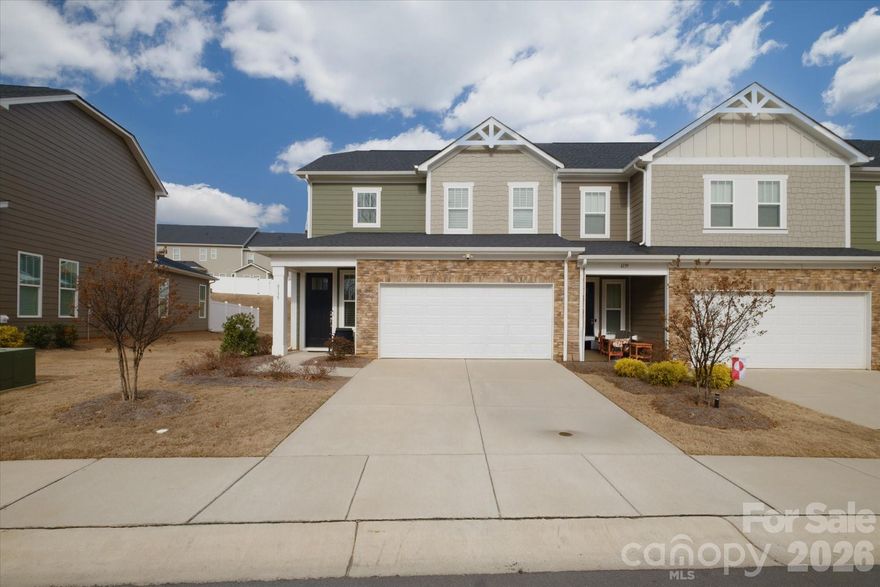 Welcome to this end unit townhome with 2 car garage in sought-after Redwood Rookery at The Vineyards, where waterfront living meets everyday convenience. Just steps from your front door, enjoy easy access to Lake Wylie, boat docks, tennis courts, two pools, and sports courts.

Inside, the open floor plan is filled with natural light and features EVP flooring throughout the foyer, kitchen, dining area, and great room. The great room opens to a private patio and fenced backyard—perfect for relaxing or entertaining.

The kitchen offers a large island with granite countertops and stainless-steel appliances. The main-level owner’s retreat includes a spacious walk-in closet and a well-appointed bath with dual vanities and a large shower.

Upstairs, you’ll find a versatile loft, a full bathroom, and two additional bedrooms, each with walk-in closets. Conveniently located just 10 miles from Uptown Charlotte and 4 miles from downtown Belmont, this home provides quick access to dining, entertainment, and shopping.