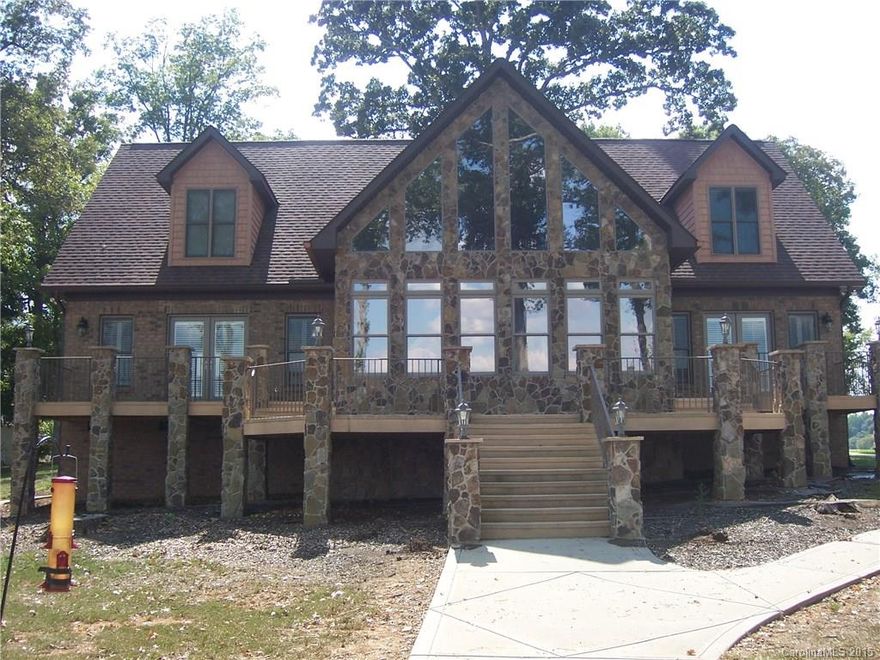 Here's the view that you have been looking for! Easy commute to Charlotte, double boat lifts. This wonderful home has 2 master suites on the main flr. Formal dinning, kitchen, great room & laundry. Upstairs has 2 more bedrooms w/ private baths, loft, & bonus room. Every room has a water view. Brazilian Cherry floors, tile, granite, & more!