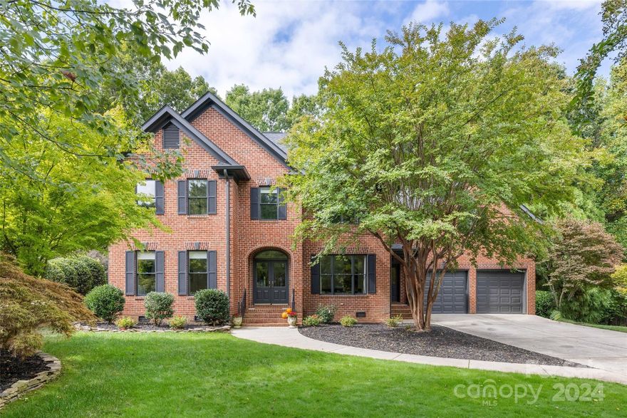 Welcome to Southport Drive, an exceptional home in the coveted Jetton Cove community. Backing to protected land, this property offers unparalleled privacy. The yard was expertly leveled with 3 tons of dirt & now features luxurious Astro turf, an oversized swingset, a 3-hole putting green & a splash pad—perfect for entertaining. The huge patio offers ample seating, while the screened-in porch, with vaulted ceilings and Trex decking, invites relaxation. Inside, the main level boasts a full bath, an updated kitchen that opens to the family living space, a butler's pantry, a walk-in dry pantry & a drop zone. In the front room, a play area with custom built-ins can easily convert to a study. The dining room features a stunning architectural arch. Upstairs are four bedrooms, three full baths, a laundry room & a huge bonus room. The primary suite includes a dreamy oversized closet & en-suite bath. Jetton Cove features walking trails, shops, restaurants, a swimming pool & fishing ponds.