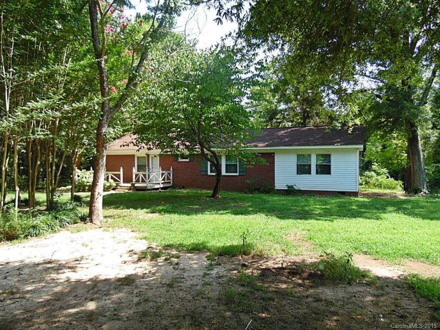 Located in a quiet setting on over an acre lot, this 4 BR/2 BA home is loaded with potential and waiting on your personal touches.  Hardwood floors, picture windows to enjoy the wooded surroundings, large kitchen with plenty of cabinet space, spacious bedrooms, wood-burning stove, and more.  Master bedroom features walk-in closet, plus master bath with separate tub and shower.  Make this one yours!